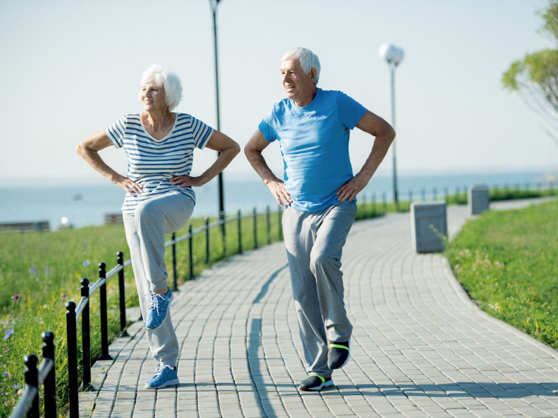 Two seniors outdoor exercising at a park