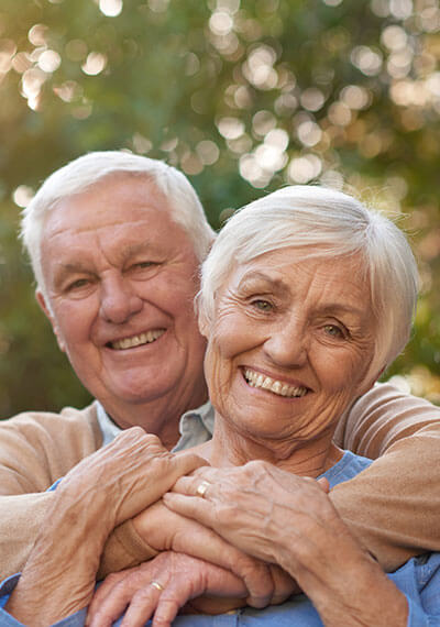 Senior couple smiling in loving embrace