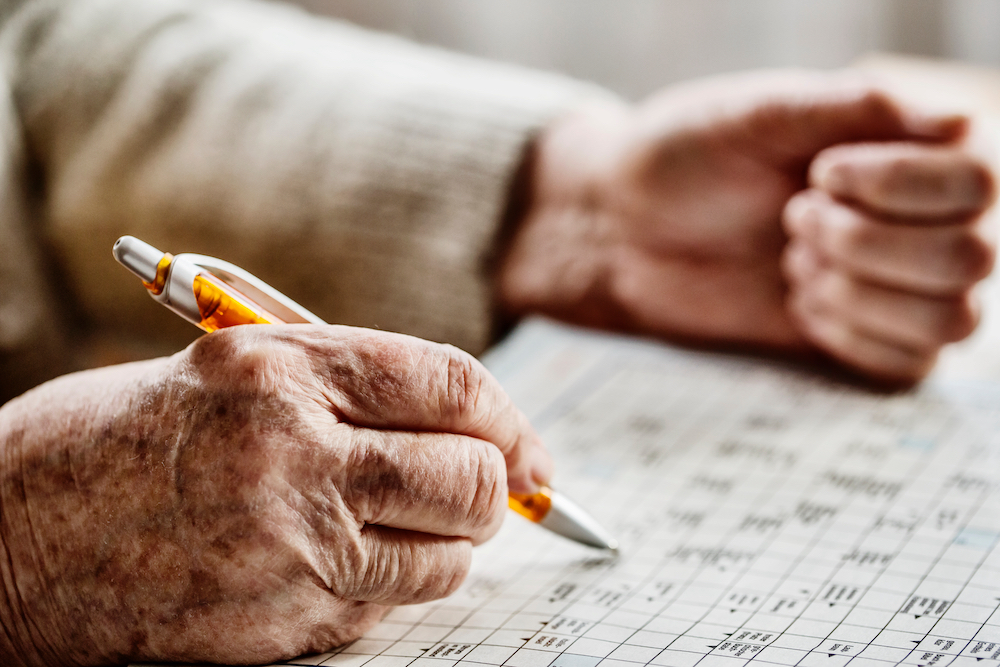 A senior woman doing a Sudoku puzzle