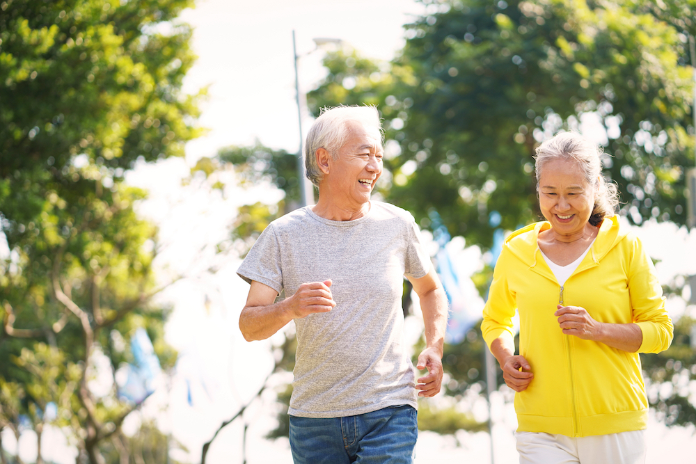A retired senior couple on a jog outdoors