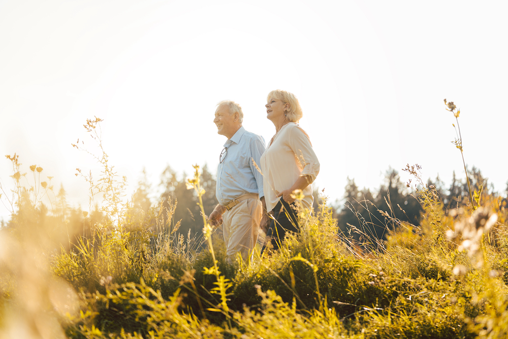 A happy senior couple goes on a walk together outdoors