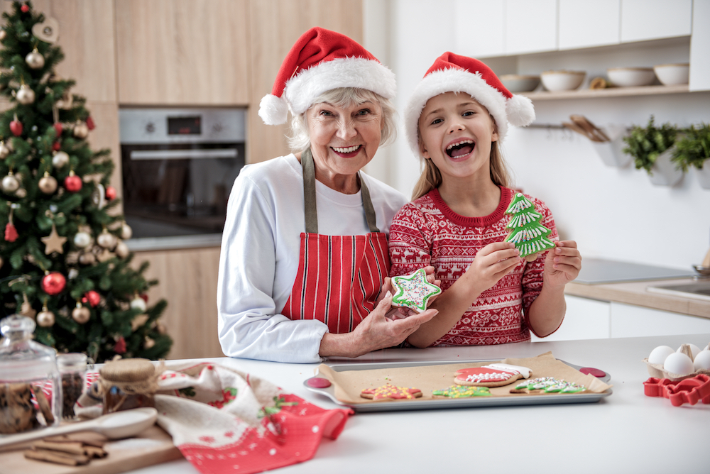 A resident of dementia memory care in Oceanside bakes holiday cookies with her granddaughter