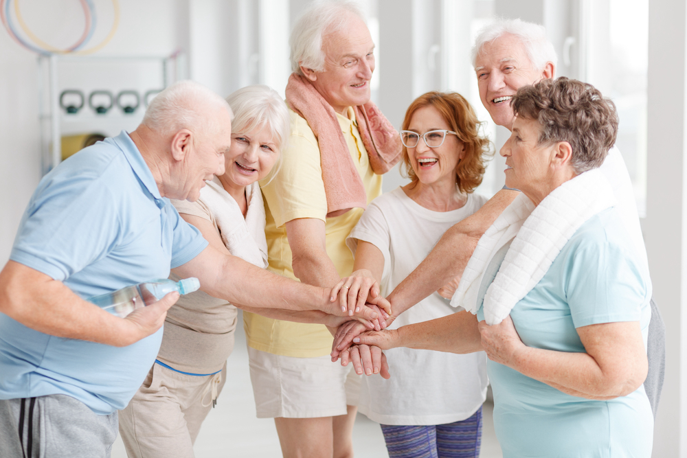 A group of seniors working out together as a part of the Oceanside memory care services