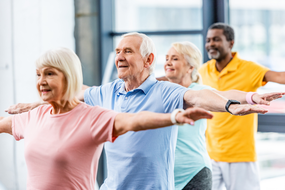 Four seniors work out together at the memory care living in Oceanside