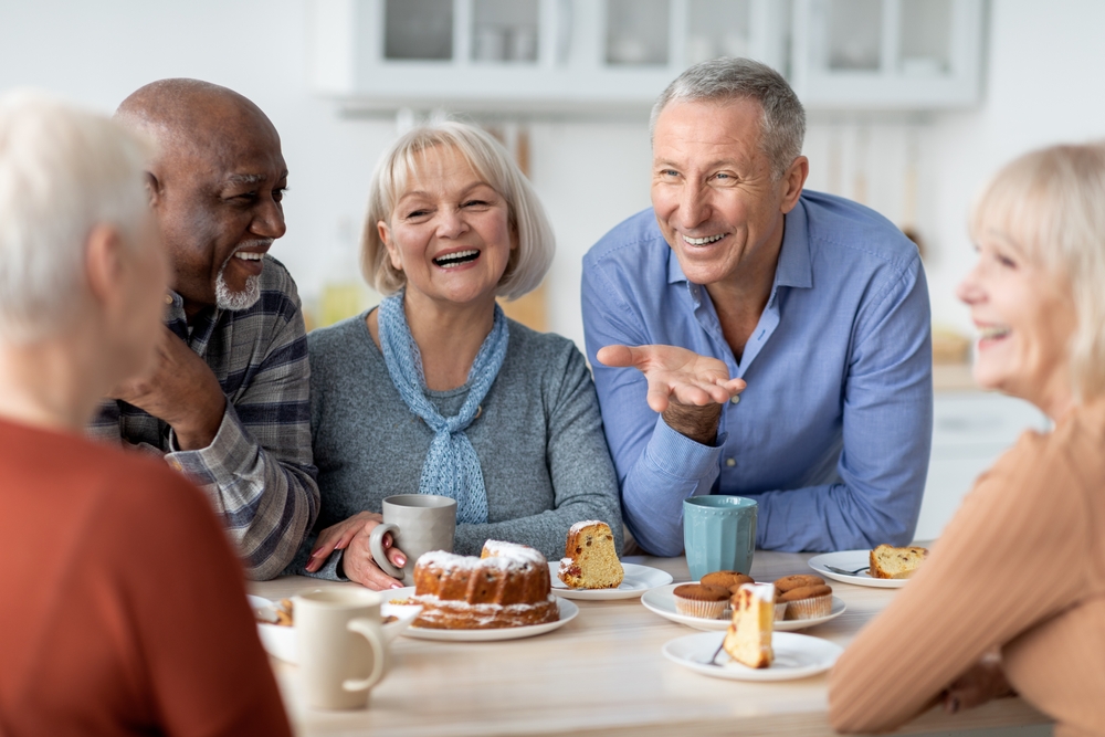 Ground of seniors having fun over a snack at a retirement community in Oceanside